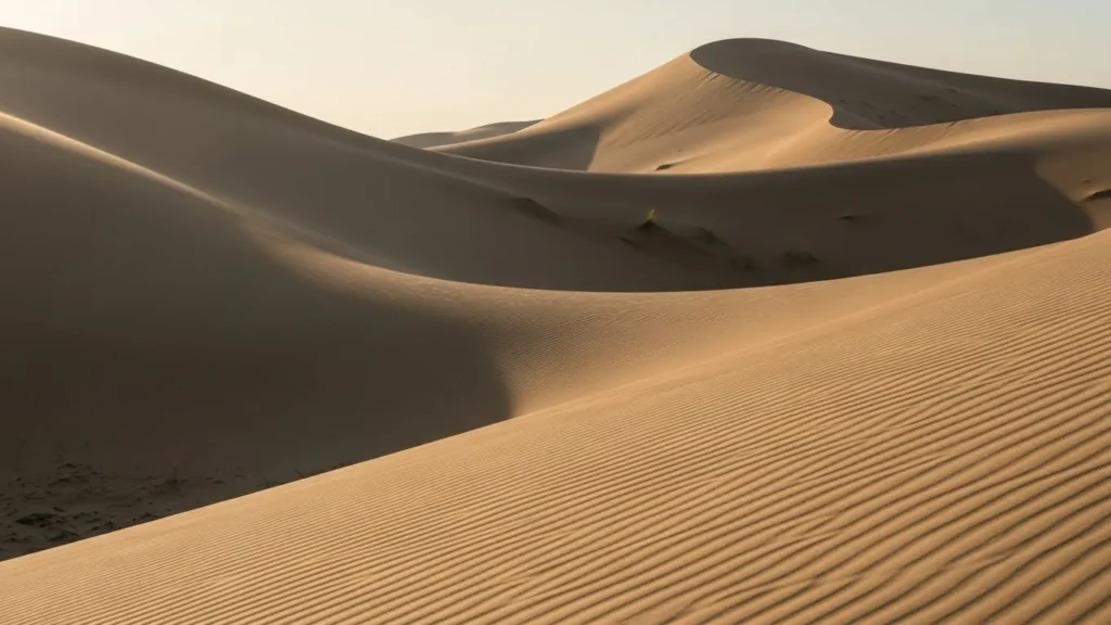 Sunset light softly illuminating a hidden desert valley between dunes in Dubai